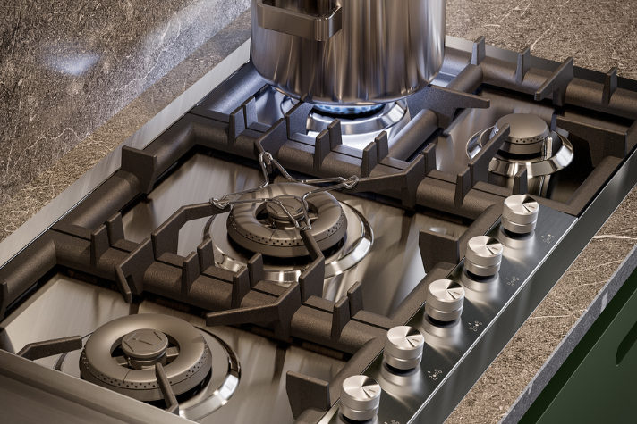 Hochwertiges Gas-Kochfeld aus Edelstahl mit Topf und mehreren Brennern in moderner Küche Modernes Gas-Kochfeld mit vier Brennern, Edelstahloberfläche und einem Topf auf einer Flamme, daneben Drehregler für die Einstellung