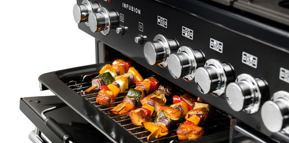 Gasherd mit geöffneter Backofentür und darin gegrillten Gemüsespießen auf dem Rost Nahaufnahme eines modernen Gasherds, auf dessen Backofengrill farbenfrohe Gemüsespieße mit Paprika, Zucchini, Zwiebeln und Fleisch liegen