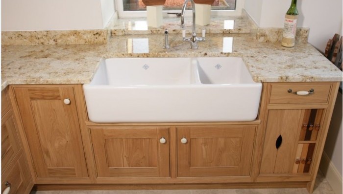 Landhausstil Küchenspüle mit Doppelbecken und Holzunterschrank Rustikale Küchenspüle mit zwei Becken, hellem Holzunterschrank und Granit-Arbeitsplatte