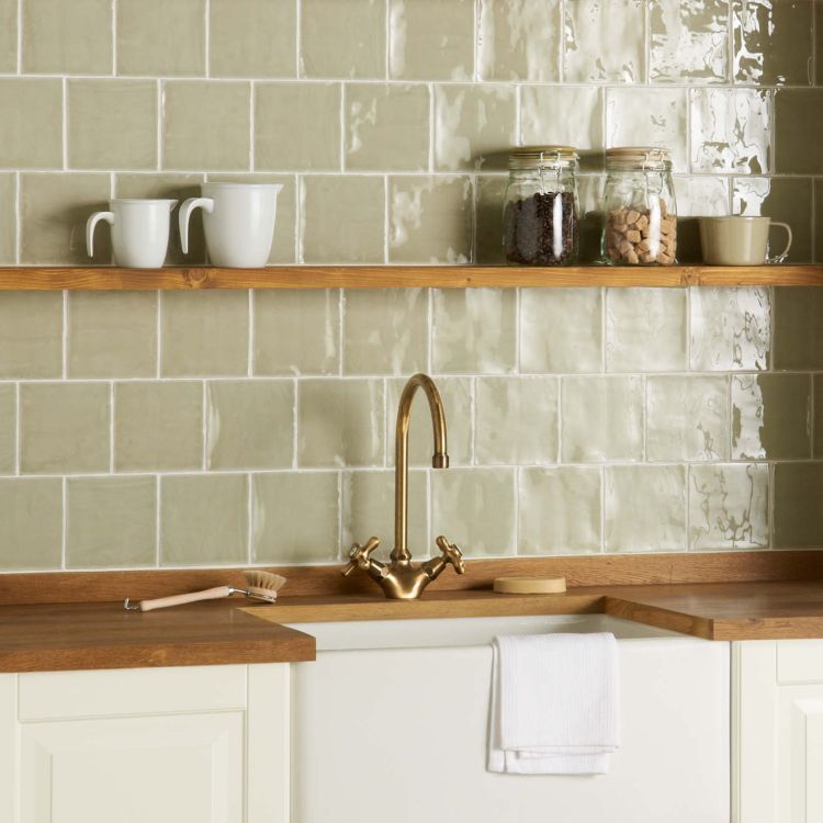 Glänzende grüne Metrofliesen, Messingarmatur, Holzregal